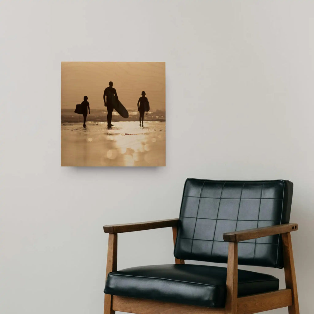A black leather armchair with wooden arms and legs.